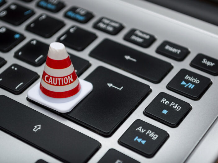 Caution cone on top of a laptop keyboard