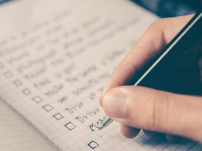 Person checking off items on checklist