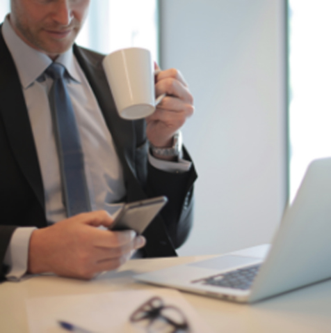 Person Holds Mug While Looking At Phone